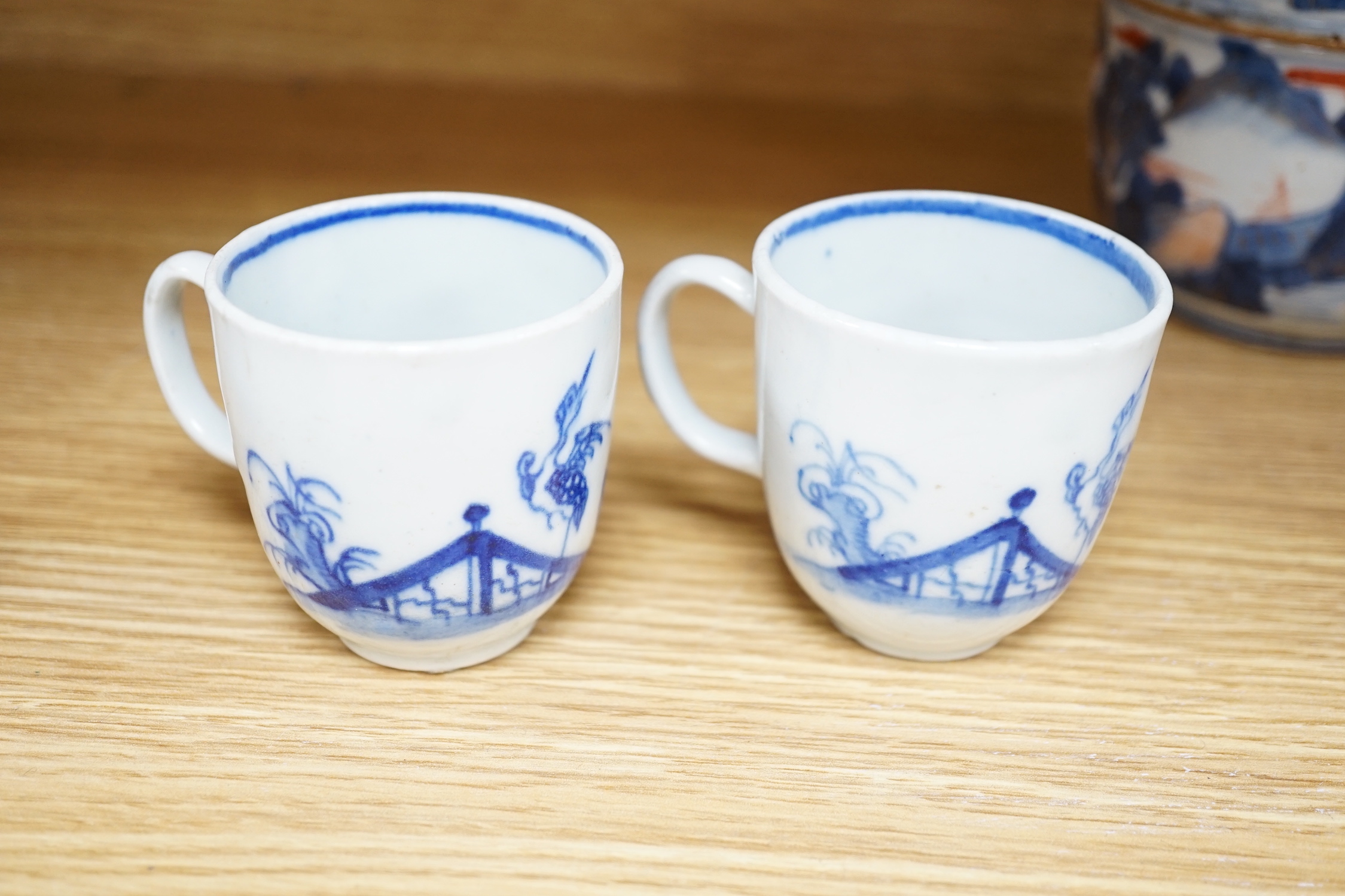 Seven various English porcelain coffee cups, including two Bristol enamelled with green floral sprays, two Bow painted in underglaze blue with a bird in a Chinese garden, and three Worcester/Bow in underglaze blue.